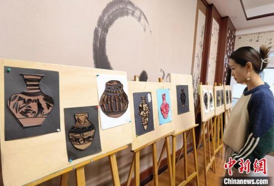 圖為學(xué)生用衍紙材料制作的彩陶紋飾?！⒂裉?攝